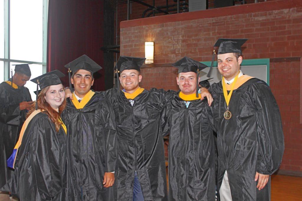 Students gathering before graduation in their cap and gowns.